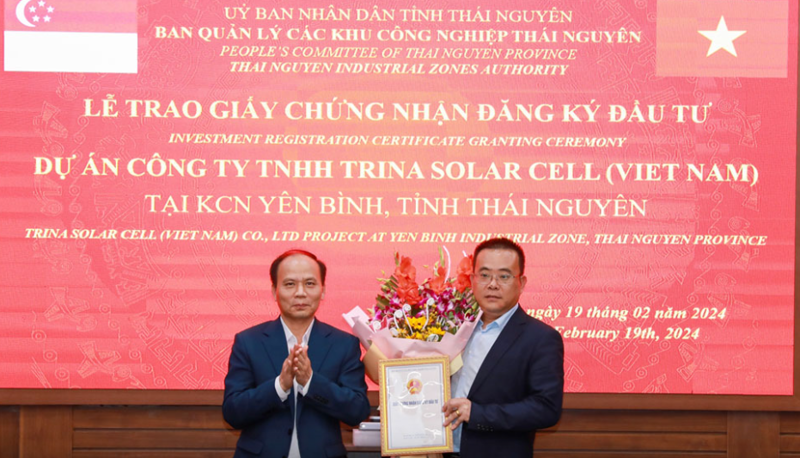 A senior official from the Industrial Zones Management Board of Thai Nguyen Province presents an investment license to the legal representative from Trina Solar Cell.