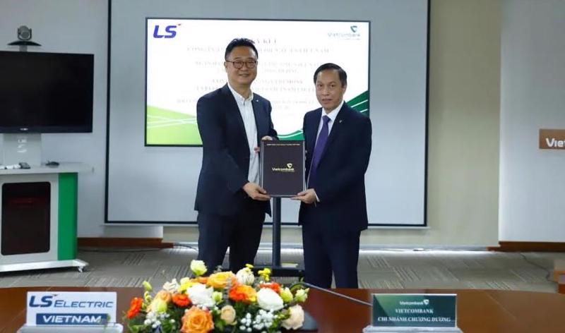 Ông Nguyễn Bá Minh - Giám đốc Vietcombank Chương Dương (bên phải) cùng ông Kim Yong Hoon - Tổng Giám đốc Công ty TNHH Thiết bị điện tử LS Việt Nam (bên trái) thực hiện ký kết.