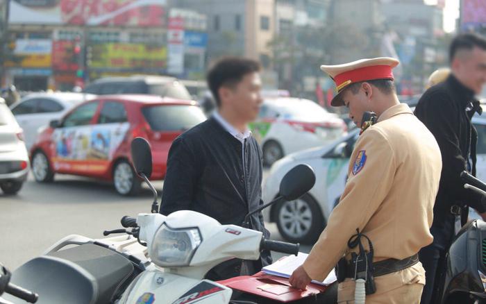Traffic policeman issues a ticket.