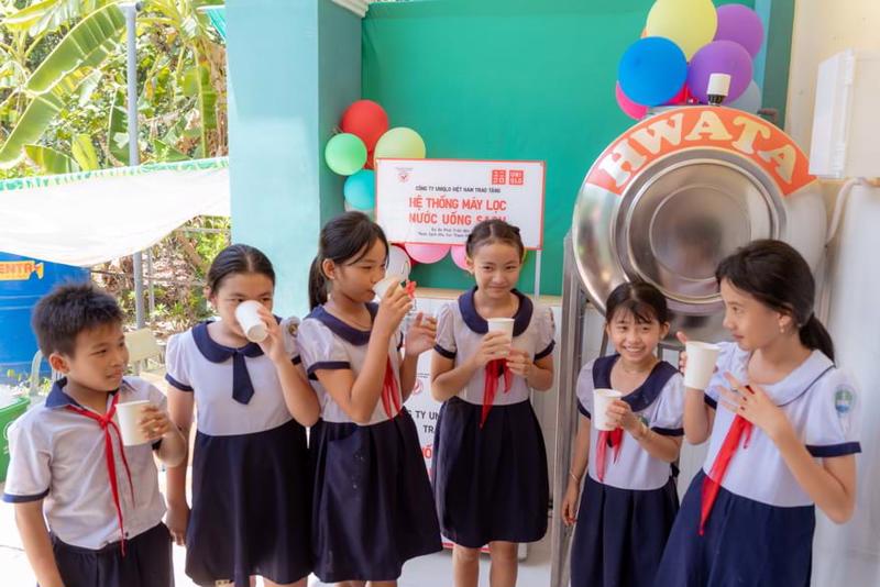 Học sinh trường tiểu học Thạnh An bên hệ thống lọc nước sạch mới.
