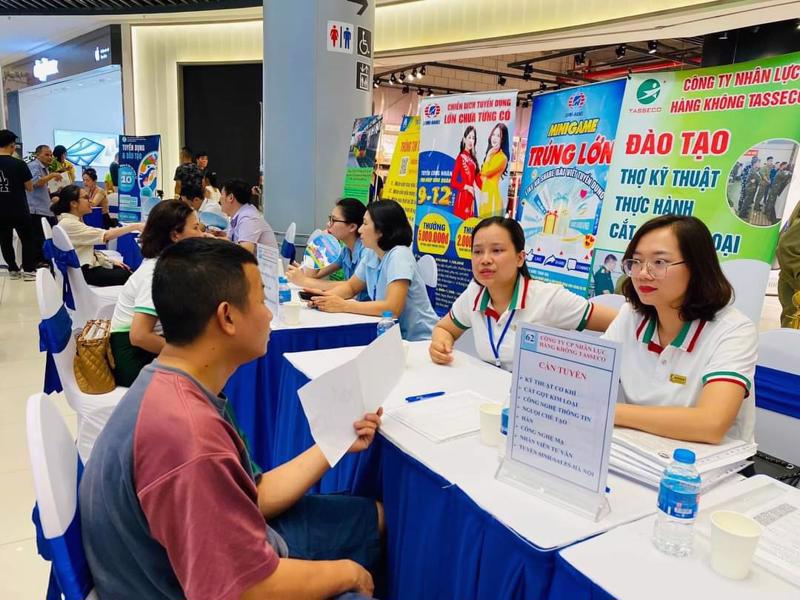 Workers seek jobs at a job fair in Hanoi. 