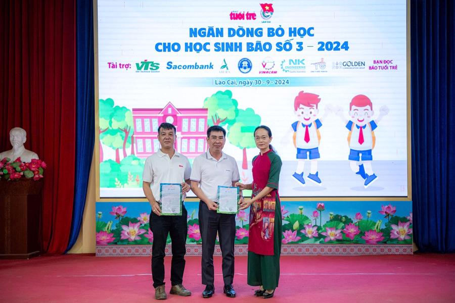 L&atilde;nh đạo huyện Bắc H&agrave; trao thư cảm ơn tới đại diện Sacombank v&agrave; b&aacute;o Tuổi Trẻ - Ảnh: Nam Trần.