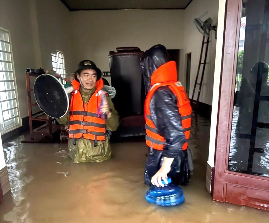 Lực lượng chức năng hỗ trợ di chuyển đồ đạc giúp các hộ dân khi nước tràn vào nhà tại Lao Bảo, Quảng Trị